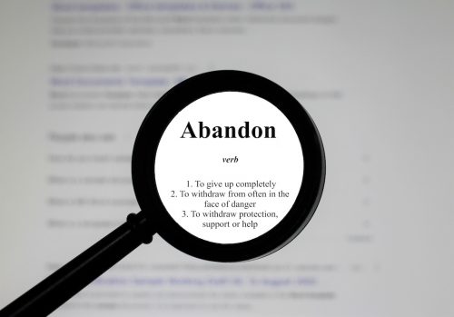 magnifying glass focused on the word abandon